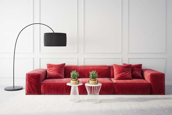Place A Lamp That Is Broad And Curved Above The Sofa